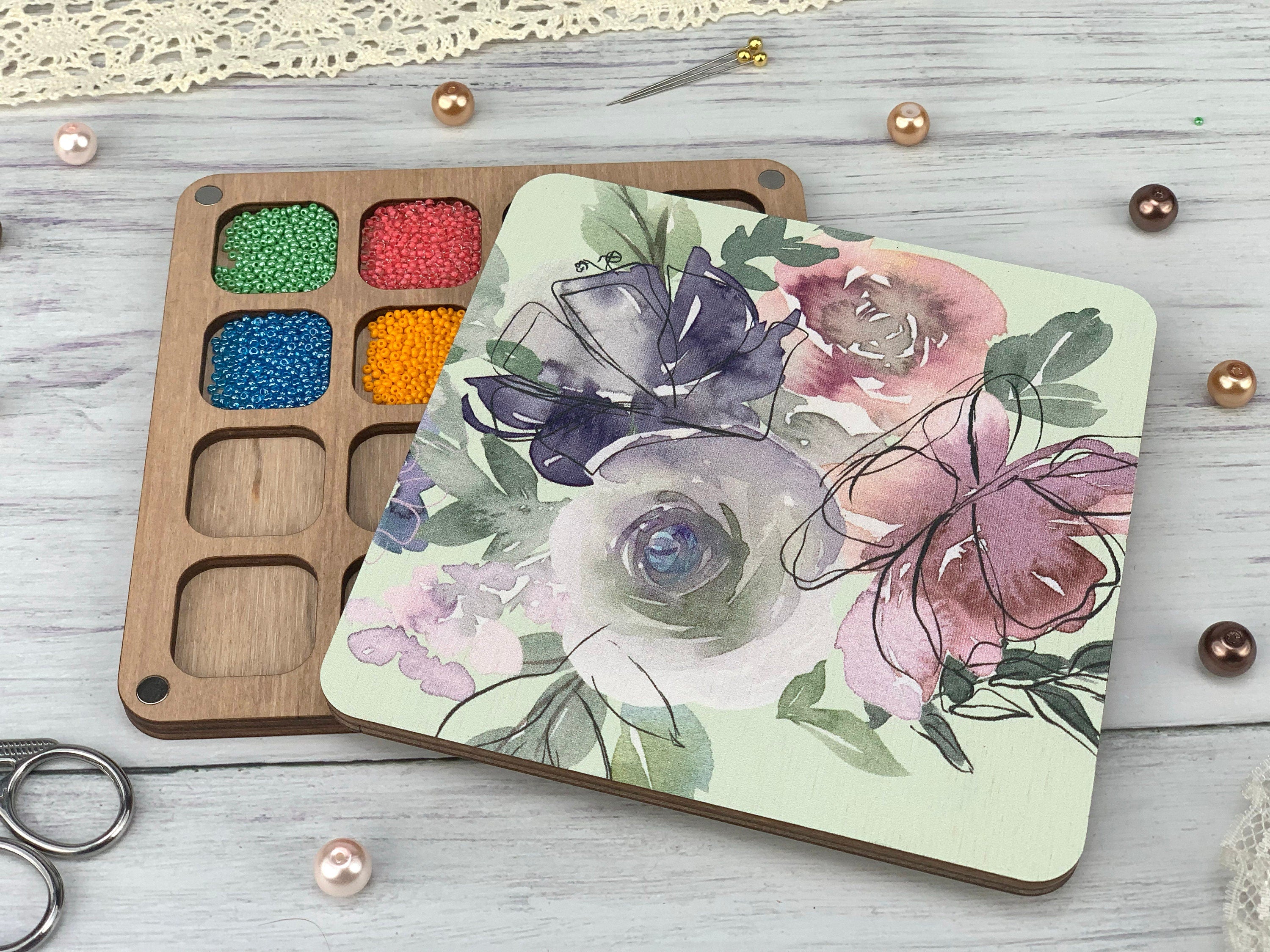 a wooden tray with a flower painted on it